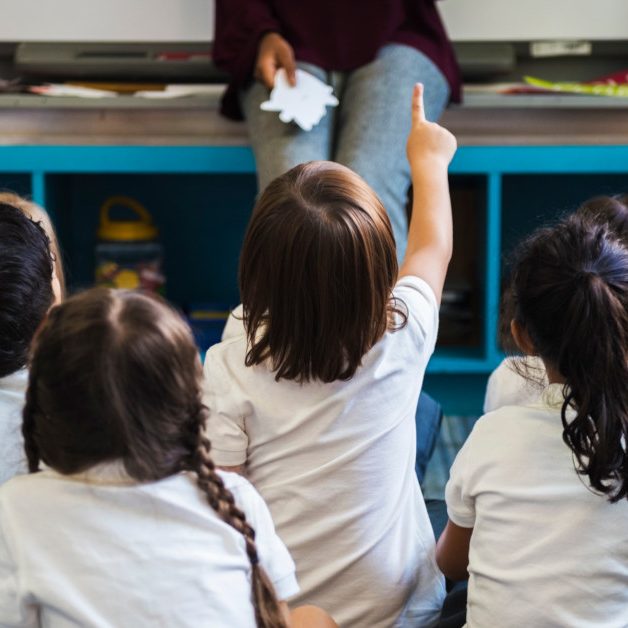 Kindergarten students sitting on the floor